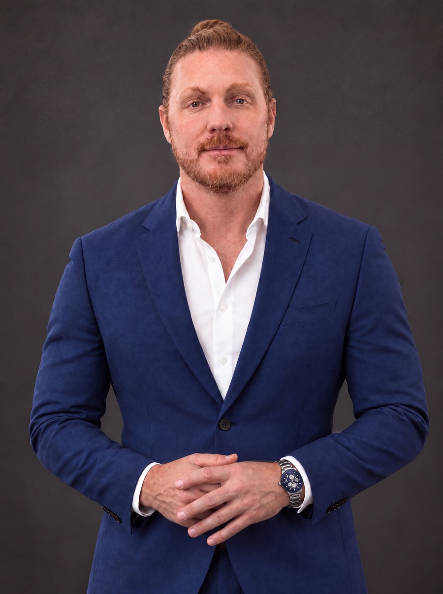 Portrait of Jacob Rosa in a navy blazer and white shirt